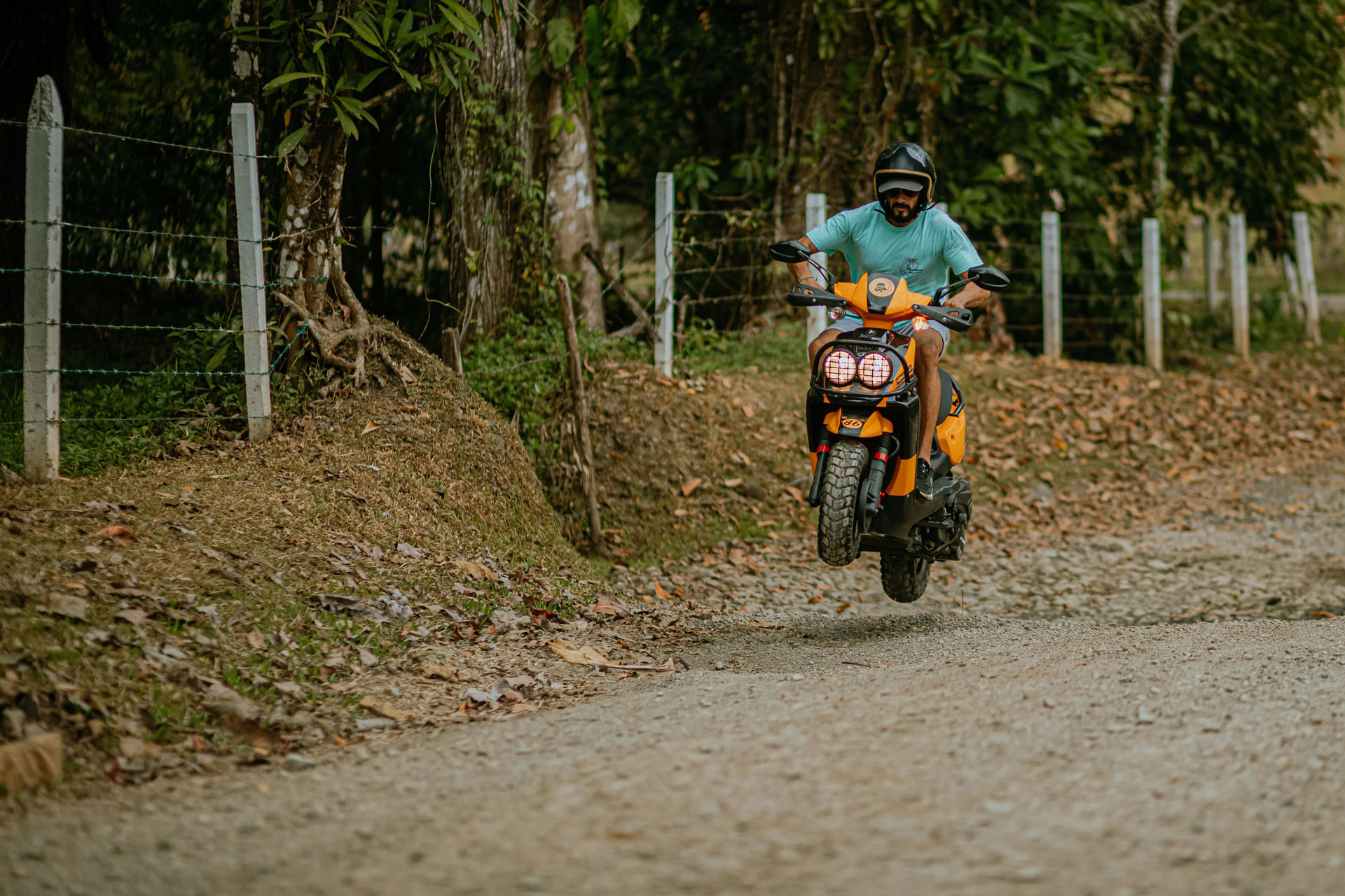 Marlon riding a scooter on a trail