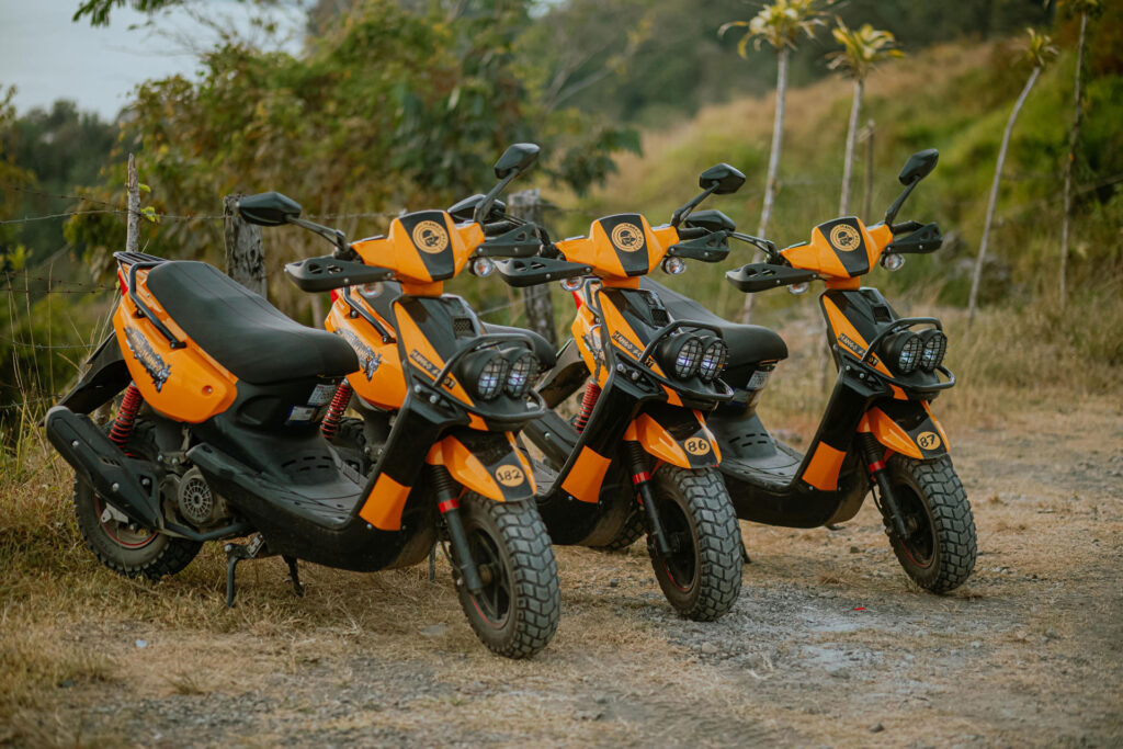 three rented scooters on side of road